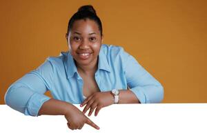Copy ,space in white color. African American woman is in the studio against yellow background photo