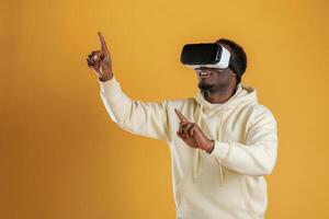 Playing VR game. .In virtual reality glasses. Black guy is against yellow background photo