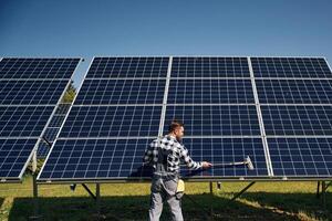 Surface, must me, clean. Engineer with photovoltaic solar panels outdoors at daytime photo