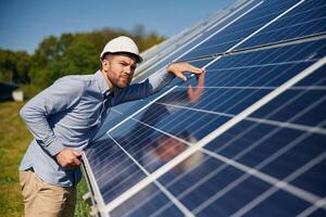 Checking,, the, surface. Engineer with photovoltaic solar panels outdoors at daytime photo