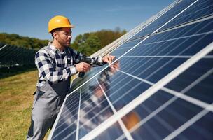 Checking, the surface. Engineer with photovoltaic solar panels outdoors at daytime photo