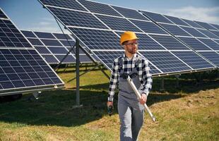 Ready,, to work, with drill. Engineer with photovoltaic solar panels outdoors at daytime photo