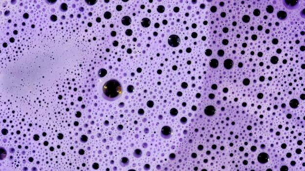 Close-up of floating bubbles and foamy texture in water, creating a light and playful visual effect photo