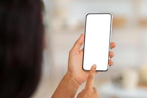 Working or studying from home remotely. African American woman touching mobile phone screen with mockup for mobile app or website design, indoors. Black lady using modern gadget photo