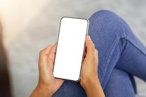 Closeup view of millennial black lady using smartphone with empty screen to work or study online from home, mockup for mobile app design. Remote education or communication concept photo