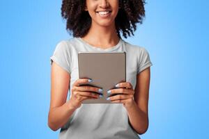Remote work, online correspondence, romantic chat and modern device. Happy millennial african american lady hold digital tablet and read message, isolated on purple background, studio shot, free space photo