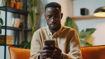 This person is focused on their phone, participating in a call while seated on a couch. photo