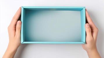 Two hands hold an open blue box that is empty, showcasing its interior. The box appears suitable for storage or delivery purposes, emphasizing its clean design and functionality. photo