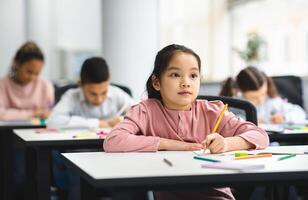 Elementary School Class. Portrait of Cute Little Asian Girl Smiling, Taking Notes And Writing in Exercise Notebook. Junior Classroom with Diverse Group of Children Learning New Stuff photo