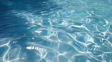 Sunlight refracting through clear, rippling water, casting mesmerizing light patterns on a soft blue surface photo