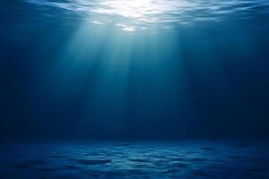 Deep ocean view with sunlight streaming through water, illuminating a vast empty ocean floor and open space for text photo