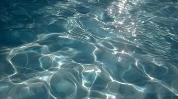 Radiant sunlight passes through clear water, creating stunning light and shadow patterns on a blue surface photo
