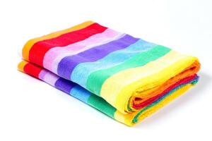 Beach towel lying flat isolated on white background with vibrant summer colors and soft texture photo