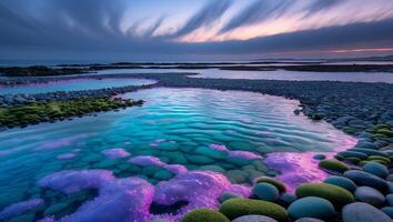 Coastal Pebble Beach with Calm Water and Dramatic Sunset Sky photo
