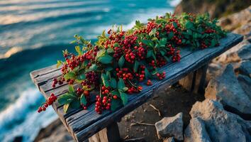 Red Berries and Green Leaves on Wooden Bench Overlooking Ocean photo