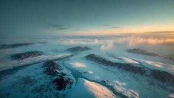 Aerial View of Snow Covered Landscape with River at Sunset photo