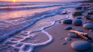 A sunset on the beach with rocks and water photo