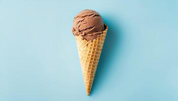 Delicious chocolate ice cream in crispy waffle cone on blue background, creating fresh and playful summer vibe. Perfect for dessert branding, ice cream advertising, and food visuals photo