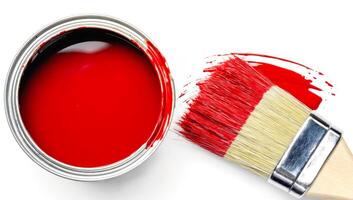 Paintbrush dipped in red paint near open can on white background. Perfect for interior design, DIY projects, color trends, painting services and home renovation branding. Flat lay photo