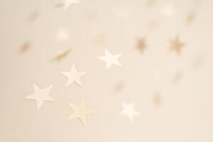 Soft Floating Paper Stars In Neutral Tones On Beige Background photo