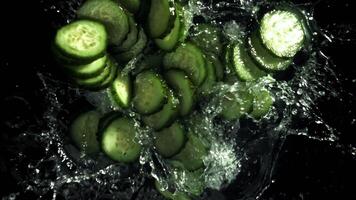 Sliced cucumbers fall into the water. Filmed on a high-speed camera at 1000 fps. High quality FullHD footage video