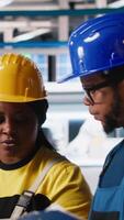 Vertical Engineering group in solar panel factory adjusting machinery settings through tablet, inspecting the production and configuration for efficient production. Teamworking. Camera A. video