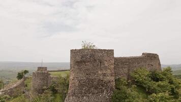 Aerial Manavi Fortress Complex. A Medieval Royal Stronghold. Strategic Hilltop Citadel Overlooking Iori Valley in Kakheti, Georgia. Hidden gem sightseeing off the beaten path attraction video