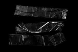 pieces of transparent tape on a black isolated backgroun photo