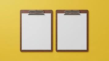 Two Clipboard with blank white paper for copy space, on clean yellow background photo