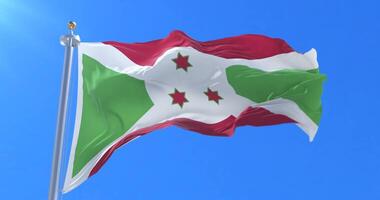 Burundi flag waving at wind in slow with blue sky loop video