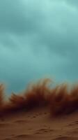 A dramatic sandstorm sweeps across the arid desert landscape with an ominous sky photo