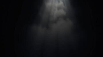 Dramatic light beams from the sky through the darkness with bright clouds photo