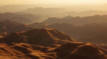 A stunning view of mountain ranges under a golden light, evoking a sense of vastness and serenity. The layers of peaks create a beautiful landscape. The sun bathes the landscape in warm hues. photo