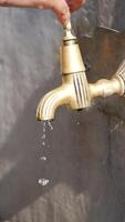 Water dripping from a vintage faucet in a rustic setting video