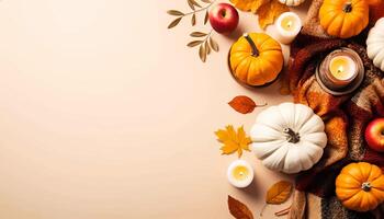 Thanksgiving background with white and orange pumpkins, apples, candles, leaves and a cloth on light beige background with copy space on the left. Top view. photo