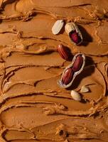 Peanut butter texture background and nuts photo