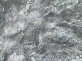 Rough concrete wall surface with natural gray abstract texture, ideal for background or design use. photo
