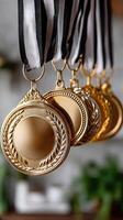 Gold medals hanging on a black and white ribbon photo