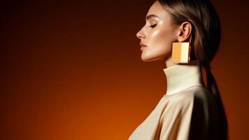 Elegant woman showcasing modern fashion accessories in a warm studio setting with orange background photo