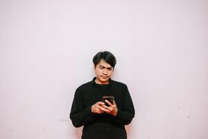 Confused Man Using Mobile Phone Reads Unexpected News Expression photo