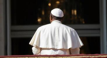 Back view of an African-American Pope standing alone on a grand balcony photo