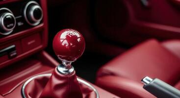Dark red cherry car interior with gear shift in focus for automotive design photo