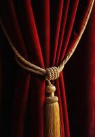 Red Velvet Curtain with Golden Tassel Symbolizing the Anticipation of Papal Announcement photo