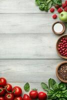 Fresh food assortment on grey wooden surface. Includes tomatoes, strawberries, raspberries, apple, herbs, and seeds with space for text photo