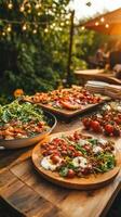 Outdoor party with fresh food. Wooden table with salad, bruschetta, and tomatoes. Greenery and lights decorate the background. Summer evening feast with fresh ingredients photo