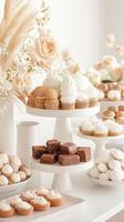 Assorted desserts displayed on white serving platters. Cakes, brownies, and tarts feature in bright studio environment. Vegetarian sweets arrangement. photo