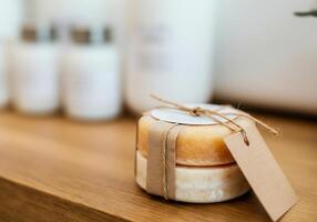 Natural artisan soap with eco-friendly packaging on wooden surface photo