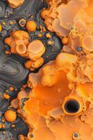 Orange liquid flows around solid textured masses. Grey substance swirls nearby. Bubbly fluid surface, an abstract vibrant landscape. photo