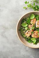Savory grilled chicken pieces are beautifully arranged on a bed of quinoa salad with fresh herbs, perfect for summer BBQ gatherings or healthy meals photo