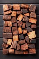 Creative composition of assorted wooden blocks, each exhibiting unique grain patterns and warm tones, ideal for craft projects or interior design concepts photo